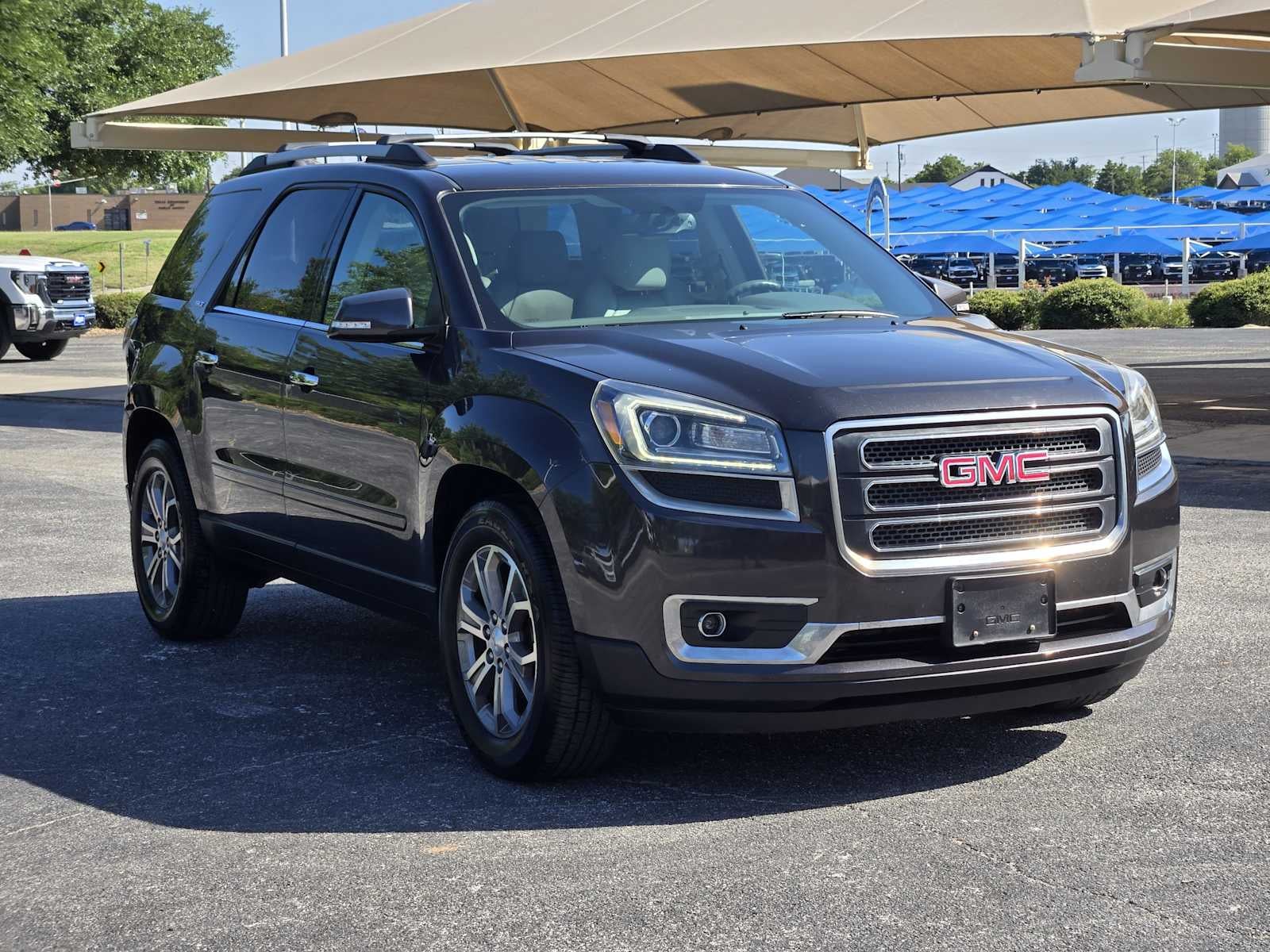 2016 GMC Acadia — rear three-quarter view