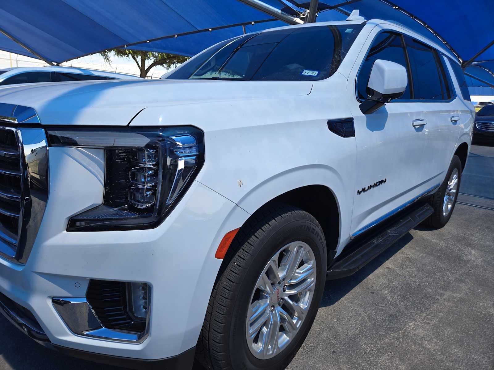2024 GMC Yukon SLT in Summit White — front three-quarter view